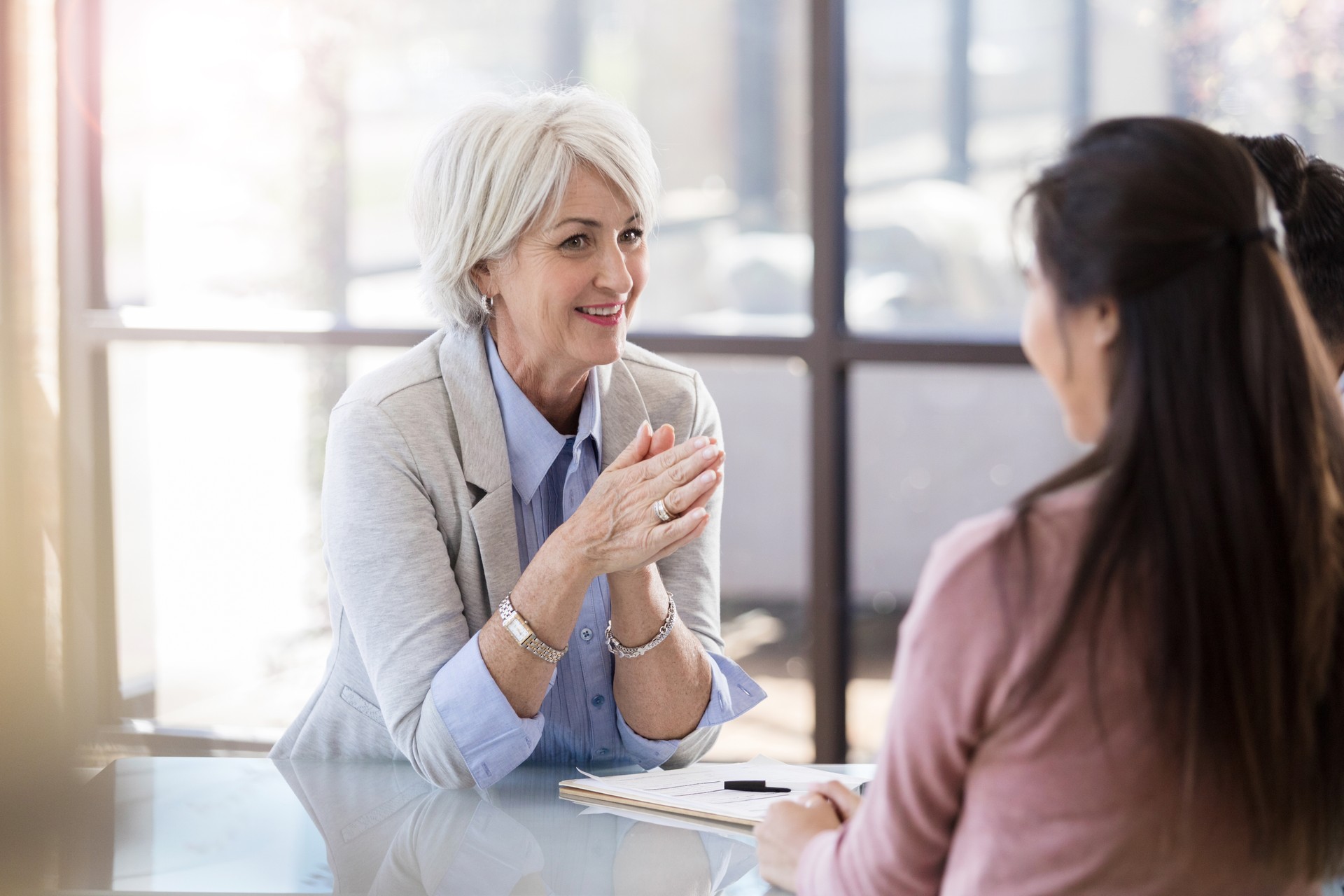 Happy doctor talks with patient